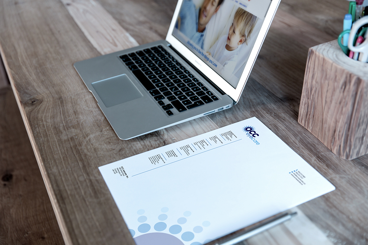 Mac Book & Letterhead On Desk Mockup