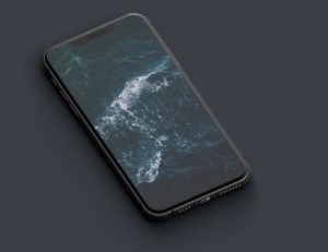 Dark iPhone 11 Pro On The Desk PSD Mockup