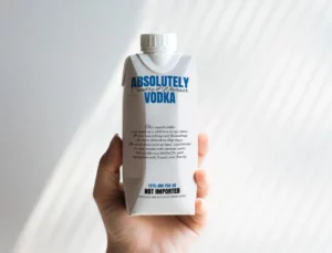 Hand Holding Paper Bottle Packaging Mockup